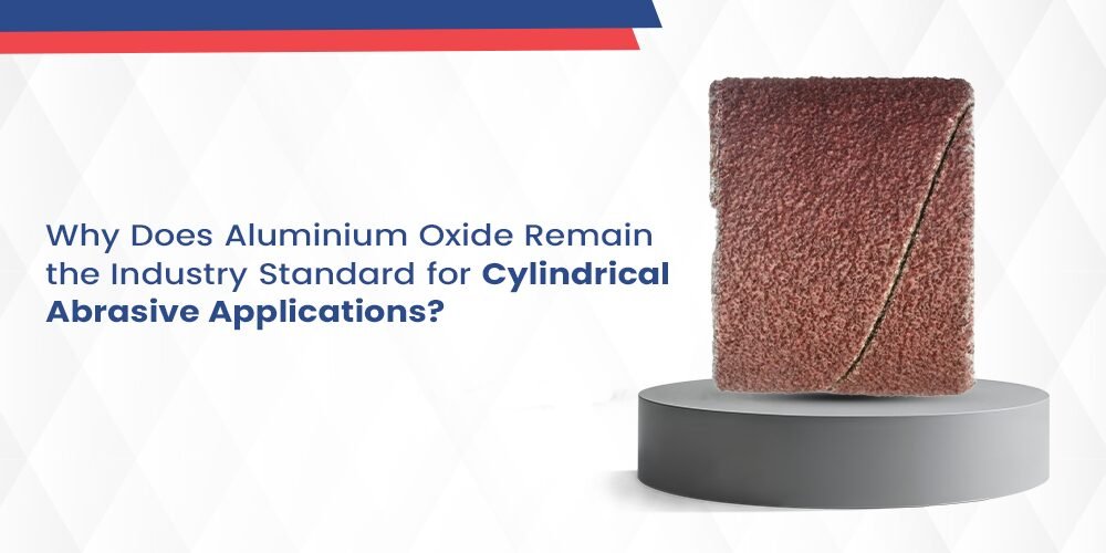 A studio photograph of a rectangular, cylindrical abrasive sleeve or sanding band, composed of reddish-brown Aluminium Oxide grit on a backing material. The abrasive wraps around itself, showing the characteristic diagonal seam. The accompanying text poses the question: "Why Does Aluminium Oxide Remain the Industry Standard for Cylindrical Abrasive Applications?" This product is used for grinding and finishing metal or wood components.